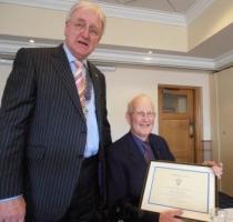 Mark Attlee receiving the citation from President Martin Wragg
